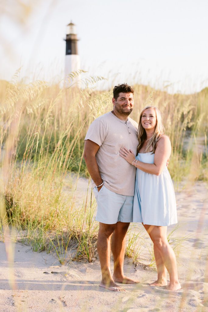 A husband and wife embrace for a portrait on Tybee's north beach.