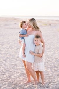 A mother embraces her sons during a Tybee island family photography session.