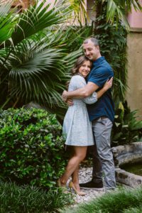 A couple embraces during their tenth wedding anniversary in the courtyard of Savannah's Forsyth Park Inn.