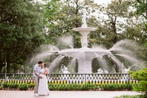 A couple in front of Forsyth Park's landmark fountain.